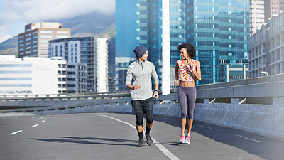 Buy stock photo Couple, talking and running in city for fitness, health and bonding together in morning with sport. People, chat and active for love, exercise and workout on bridge with teamwork training in urban