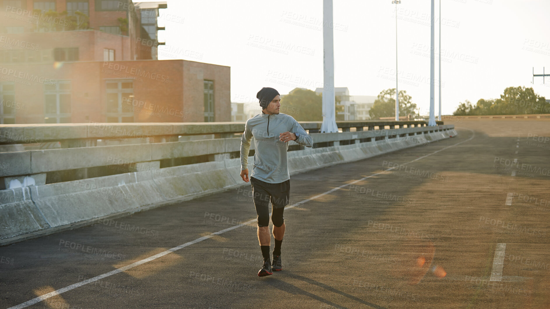 Buy stock photo Man, runner and sunrise in bridge, training and outdoor for fitness, exercise and health in morning. Person, city and direction on metro street at dawn for workout, progress and prepare for marathon