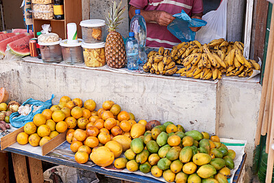 Buy stock photo Street vendor, person and selling fruit for profit with vitamin c, health and shopping for organic grocery. Food, vegetables and entrepreneur with banana for nutrition and outdoor market in Brazil