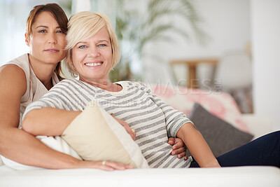 Buy stock photo Portrait, smile and lesbian couple relax in home together for love, support and care. Face, lgbtq and happy queer women on sofa for connection, loyalty or trust in healthy relationship in living room