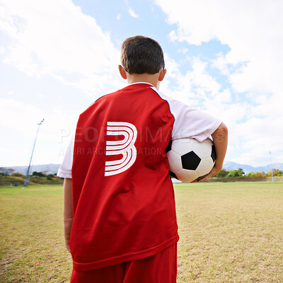 Buy stock photo Child, back view and soccer player on field for training, workout and ready for practice on grass. Boy, athlete and ball for exercising and skill development, fitness and wellness or sports and game