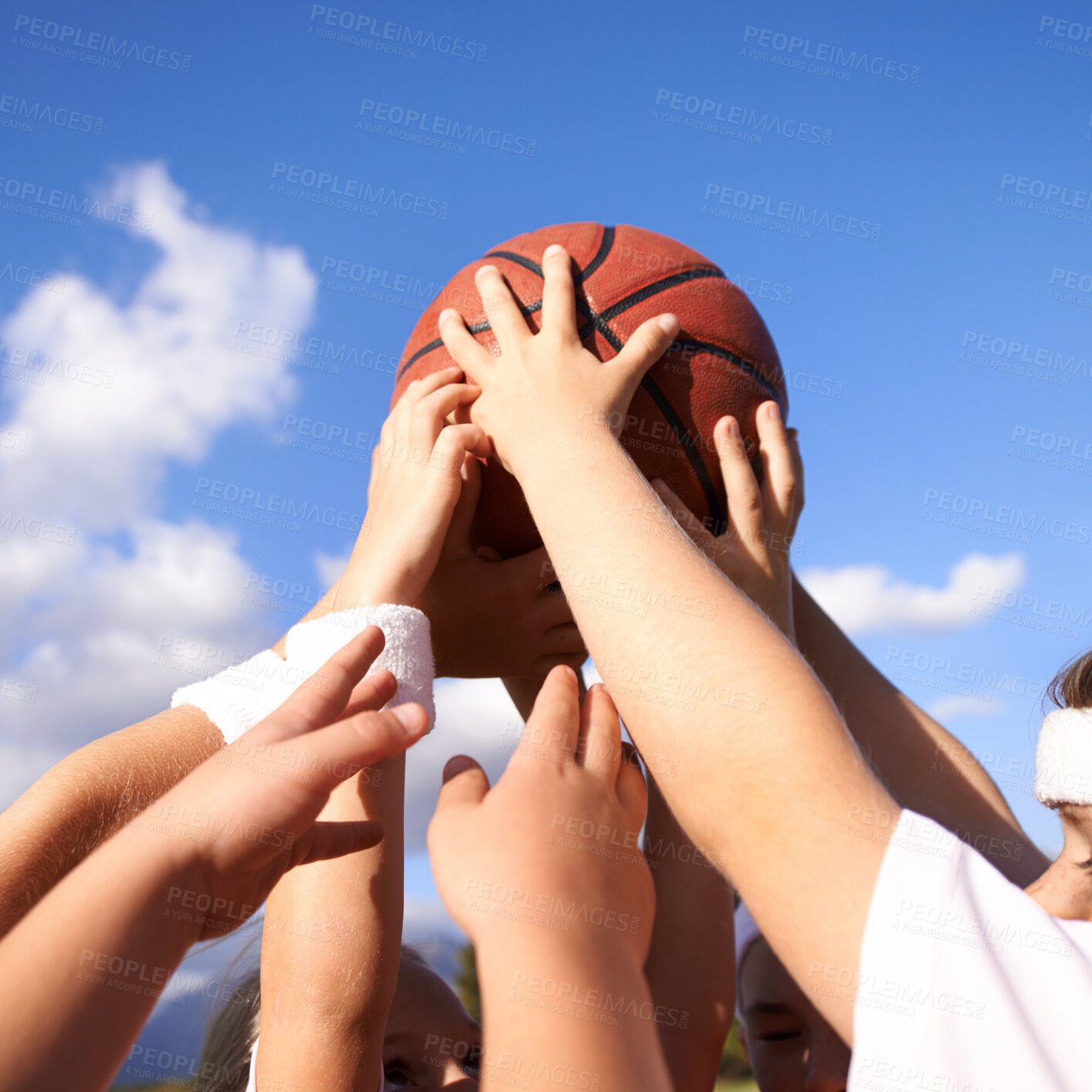 Buy stock photo People, hands and basketball in team sports for motivation, unity or community with blue sky background. Closeup group of players holding ball up in air for friendly match or outdoor game in nature 