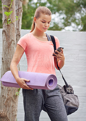 Buy stock photo Yoga mat, phone and girl at park for fitness, exercise schedule and virtual lesson on app. Mobile, pilates and woman outdoor for healthy body, scroll and reading wellness blog for guide on internet