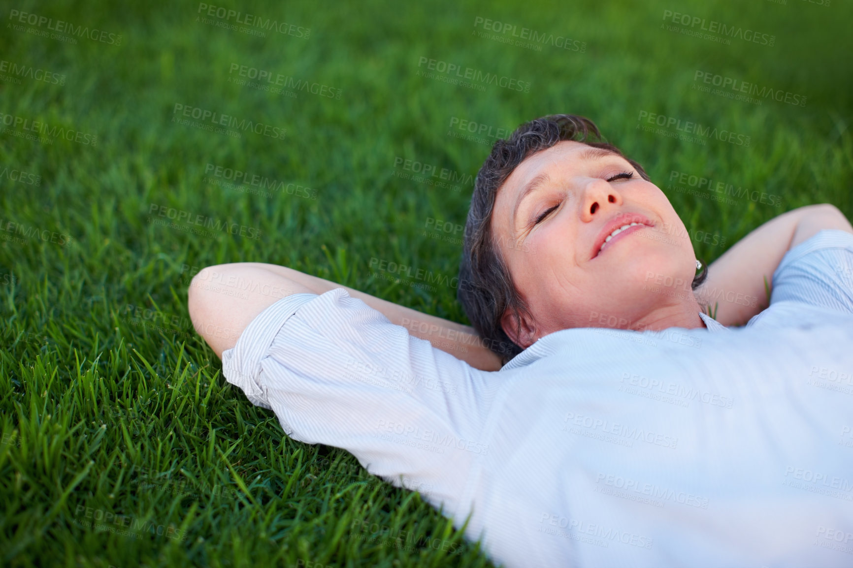 Buy stock photo Woman, peace and relax on grass space for comfort, zen and positive mental health. Resting, mature person and smile in nature park for summer travel, freedom and stressless environment for wellness