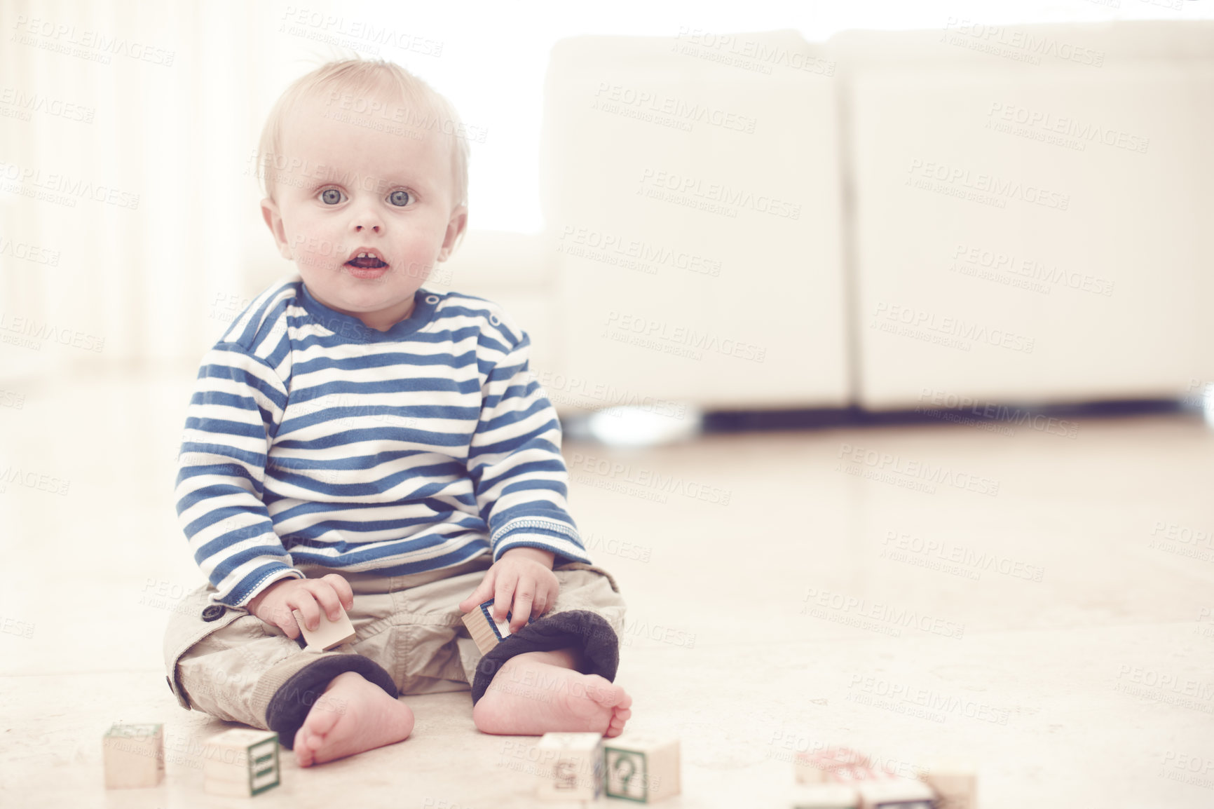 Buy stock photo Toddler, boy and portrait with building blocks in home with playing, fun and learning for child growth. Baby, kid and serious with educational games for brain or language development at living room