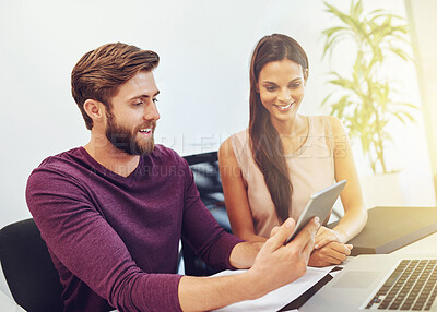 Buy stock photo Cropped shot of two young architects looking at a digital tablet