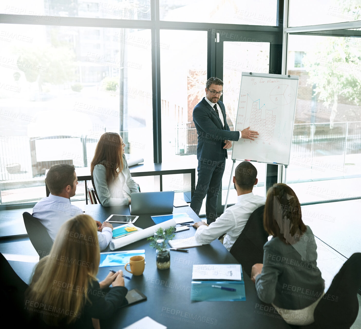 Buy stock photo Shot of a businessman giving a presentation to his colleagues in an office