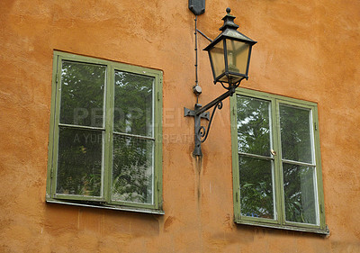 Buy stock photo Vintage home, building and window in city with lamp, grunge wall and apartment outdoor. Glass, house exterior and facade of old architecture for design, construction and real estate property in UK