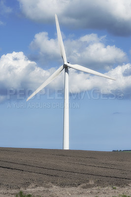 Buy stock photo Blue sky, clouds and landscape with wind turbine for renewable energy outdoor to produce electricity. Field, nature and recycling with windmill in nature environment for conservation or power supply