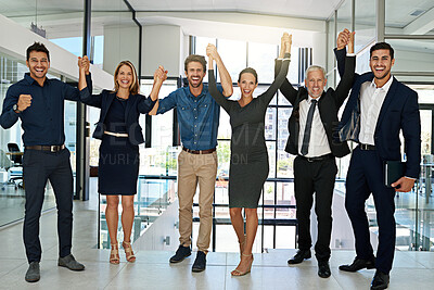 Buy stock photo Portrait of a confident looking team of coworkers sheering together while standing in a modern office