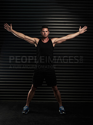 Buy stock photo Arms, open and man with portrait in gym for fitness pr exercise, healthy living and serious for wellbeing or wellness. Person, black background and determined for physical cardio or muscle strength.