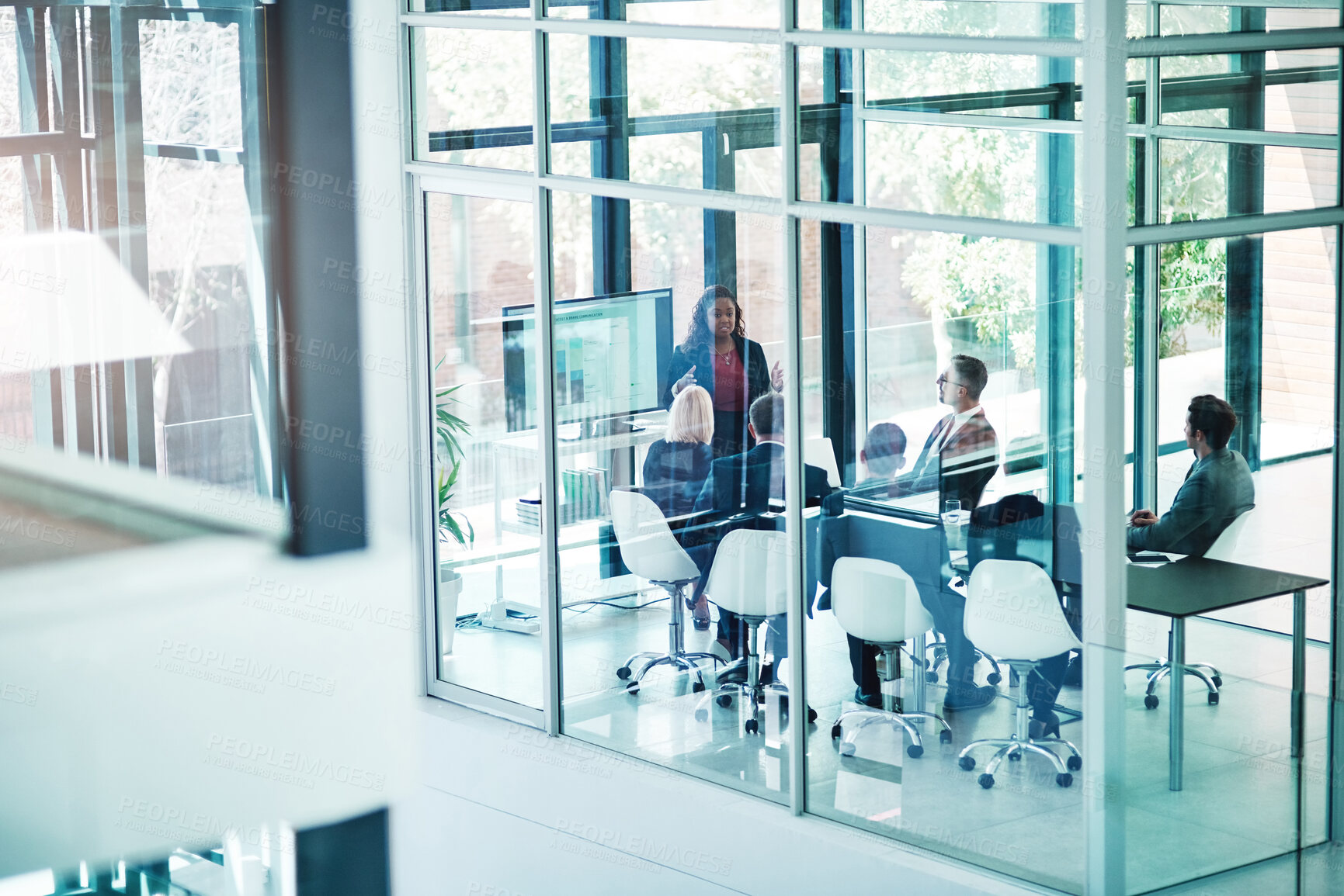 Buy stock photo High angle shot of an attractive young businesswoman giving a presentation in the boardroom