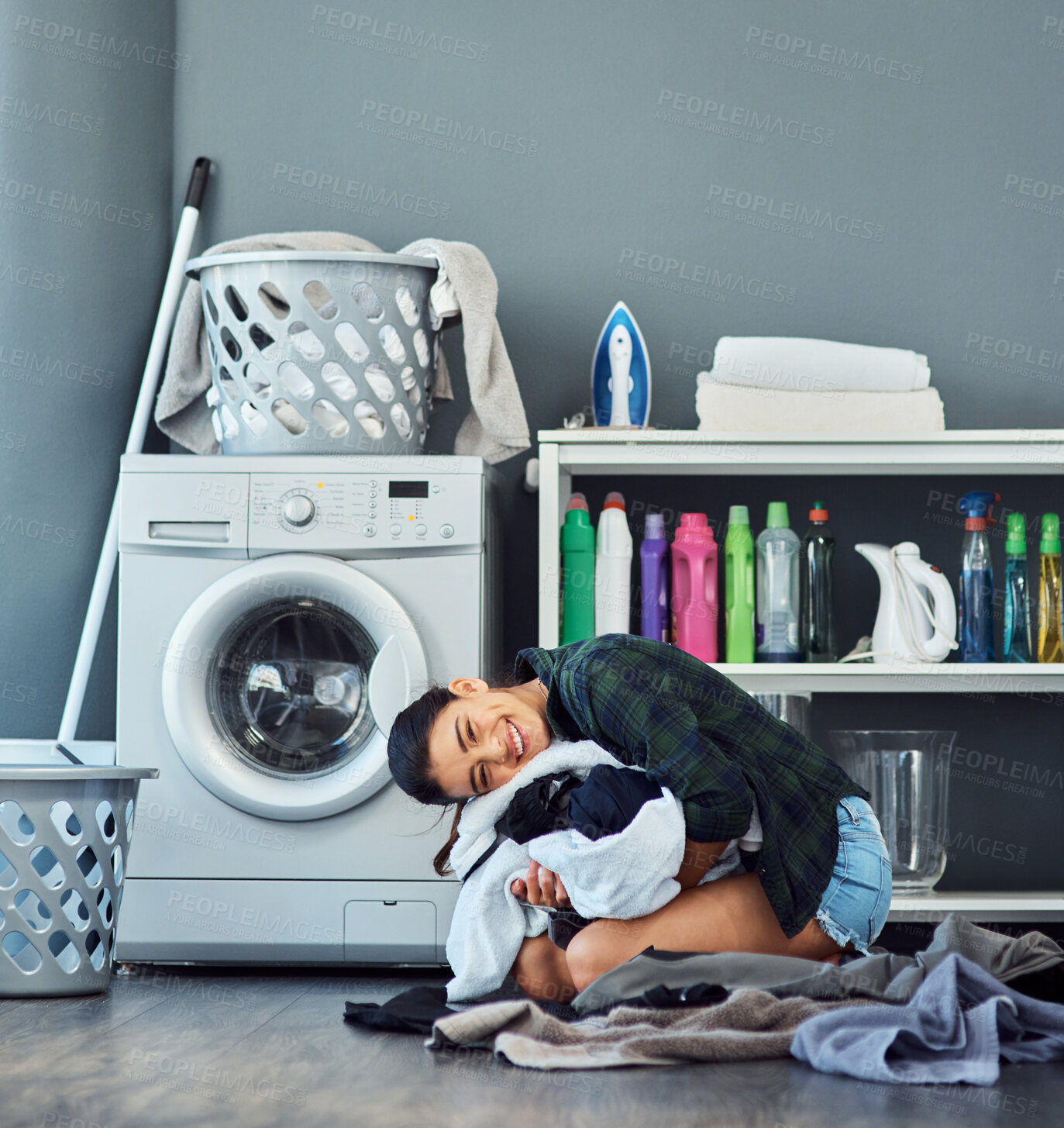 Buy stock photo Laundry, woman and hug of clothes, washing machine and spring cleaning in weekend, linen and routine in house. Housework, portrait and person with chores, fabric and happy with results of hygiene