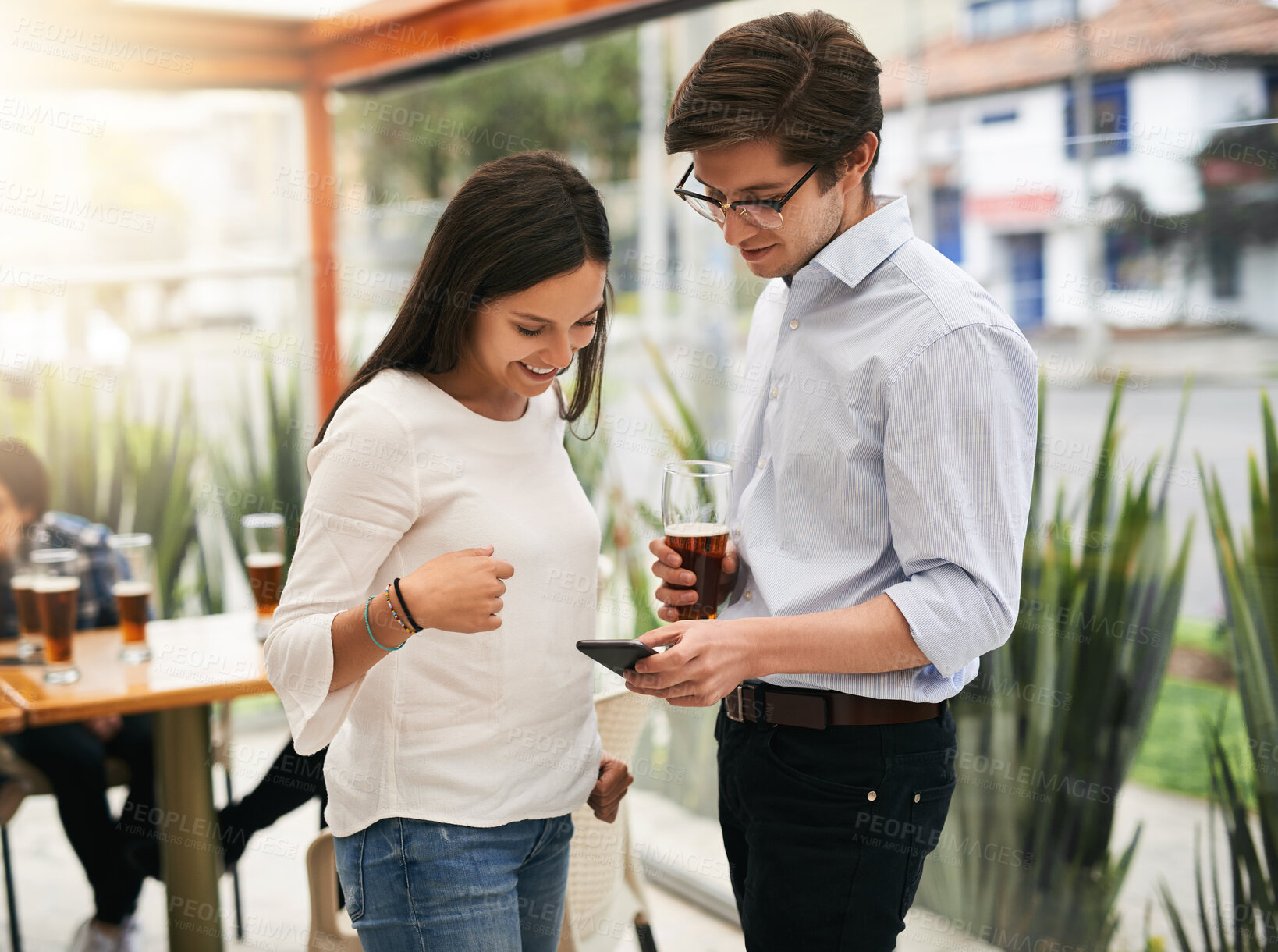 Buy stock photo Phone, people and cafe with business people after work with social media scroll and website. Meme, restaurant and lunch meeting with discussion, conversation and smile from online post at coffee shop