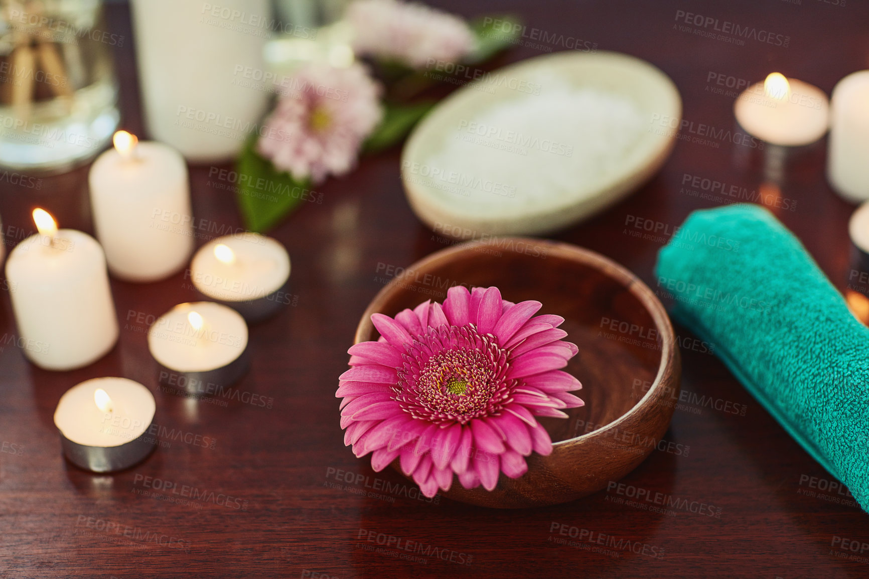 Buy stock photo Holistic, beauty and flower with bowl in spa for salon, alternative treatment and balance. Detox, skincare and zen with candles and massage therapy products for luxury, wellness and aromatherapy