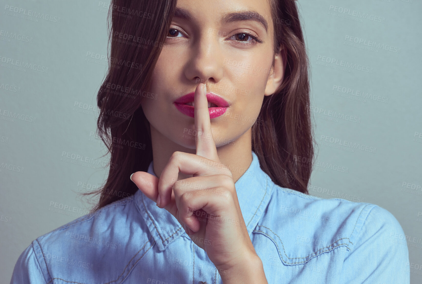 Buy stock photo Woman, portrait or secret with private gossip, confidential tips or beauty tricks on a studio background. Young face, female person or attractive model with finger on lip for silence, mystery or hush