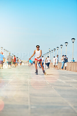 Buy stock photo Shot of an attractive young woman rollerblading on a boardwalk