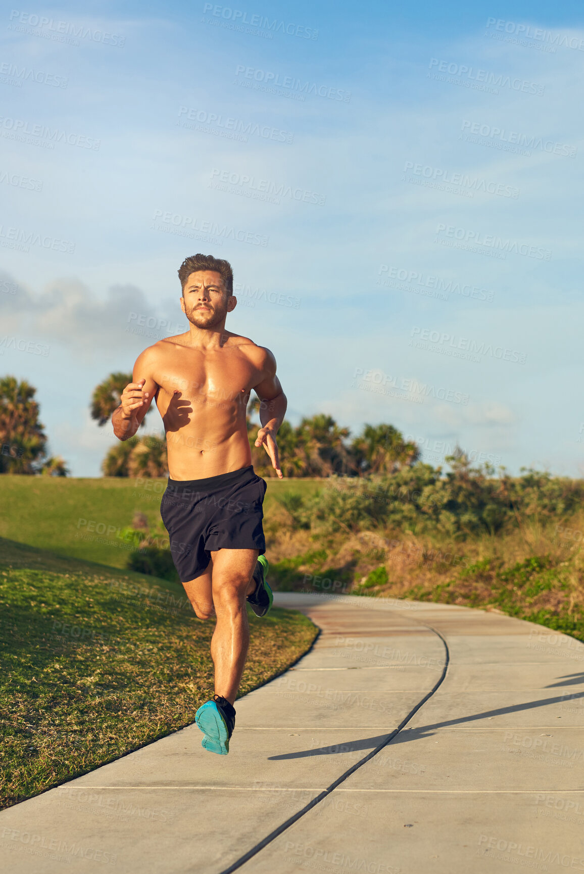 Buy stock photo Fitness, shirtless and man running in park for cardio, challenge and training for marathon in summer. Topless person, serious and muscular athlete with energy for outdoor sport, exercise and workout