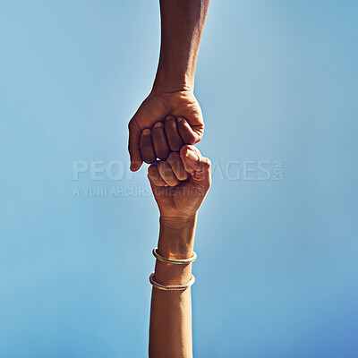 Buy stock photo People, hands or greeting with fist bump below blue sky background for winning, motivation or agreement in nature. Low angle, closeup or friends with touch in support, partnership or mission on space