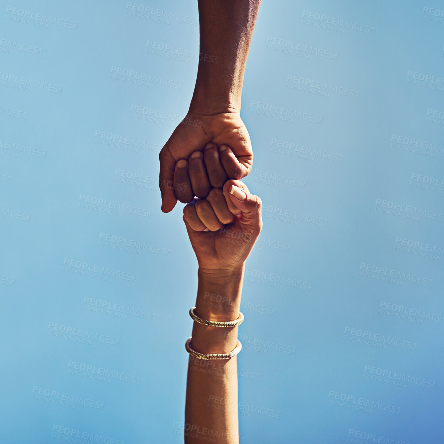 Buy stock photo People, hands or greeting with fist bump below blue sky background for winning, motivation or agreement in nature. Low angle, closeup or friends with touch in support, partnership or mission on space