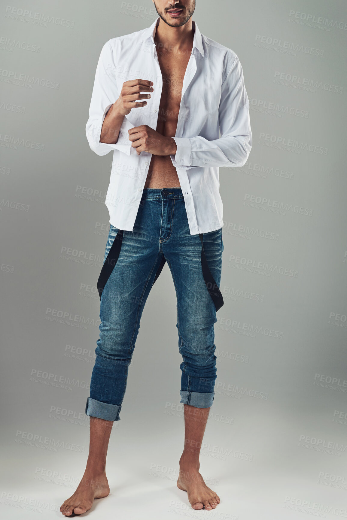 Buy stock photo Fashion, style and body of man in studio for casual, confidence and urban clothes. Dressing, getting ready and jeans with person on white background for creative, designer and model aesthetic