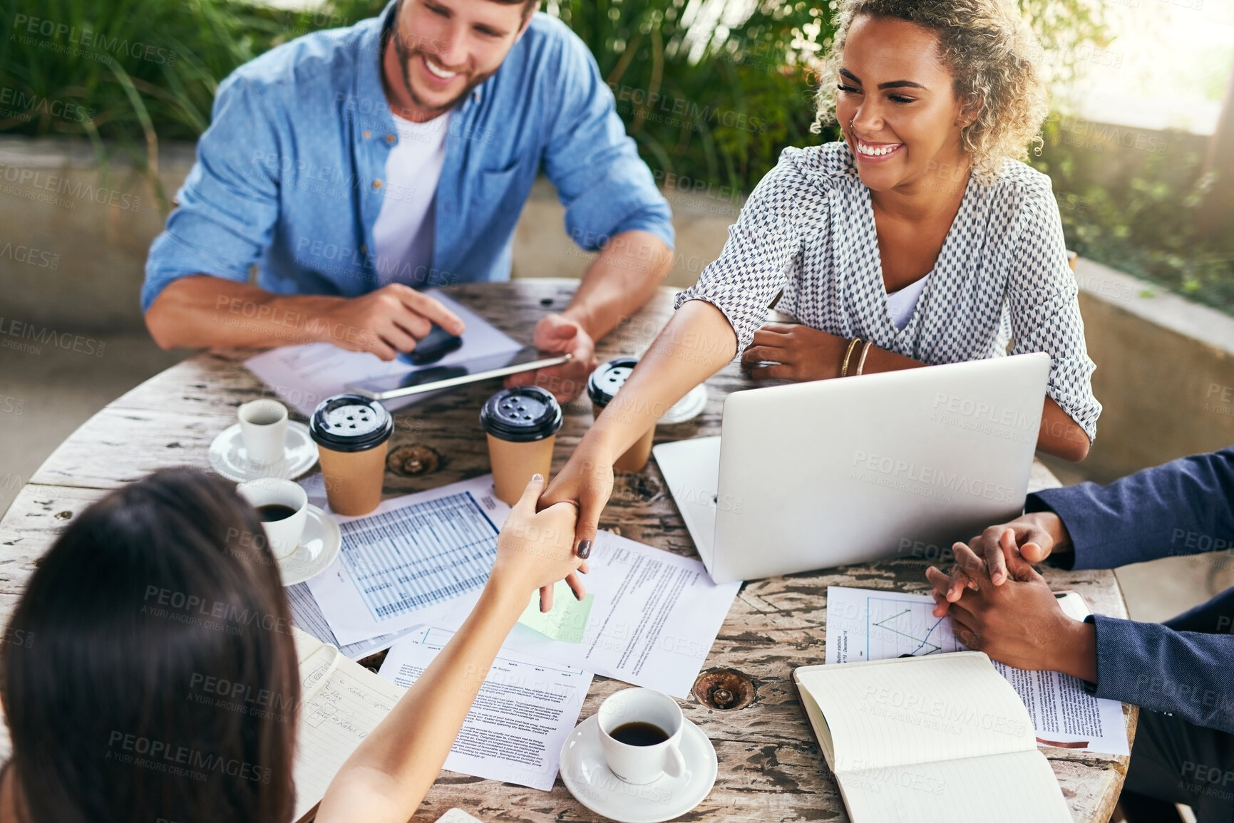 Buy stock photo Happy, business people and meeting with handshake for greeting, collaboration or introduction at outdoor cafe. Young, group or employees shaking hands for teamwork, deal or agreement at coffee shop