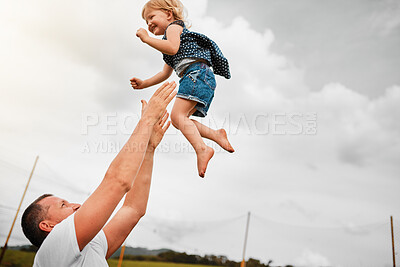 Buy stock photo Dad, air and bonding with child, outdoor and catching of daughter, trust and games for family and nature. Sky, happy and fun of girl, care and man in fathers day, clouds and playing with toddler