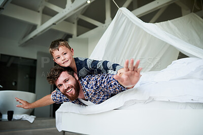 Buy stock photo Father, airplane and boy in home for bonding, relax and playing together on bed on weekend. Family, flying and happy child for support, development and childhood fun with games, plane and superhero