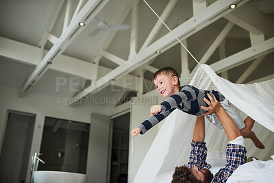 Buy stock photo Father, airplane and boy in home for bonding, relax and playing together on bed on weekend. Family, flying and happy child for support, development and childhood fun with games, plane and superhero