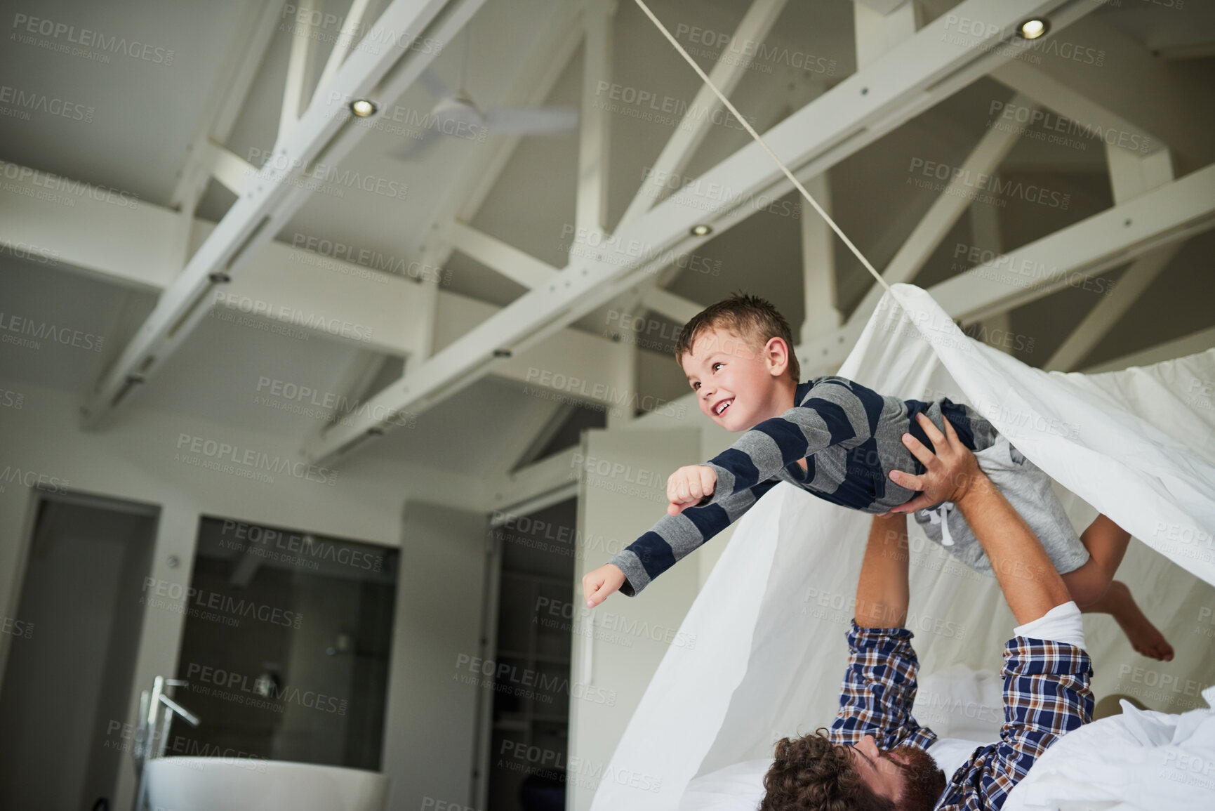 Buy stock photo Father, airplane and boy in home for bonding, relax and playing together on bed on weekend. Family, flying and happy child for support, development and childhood fun with games, plane and superhero