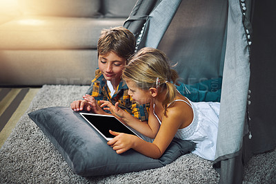 Buy stock photo Tablet, relax and kids in tent in home playing online educational game for learning. Rest, digital technology and children siblings watching video for entertainment in blanket fort for fun at home.