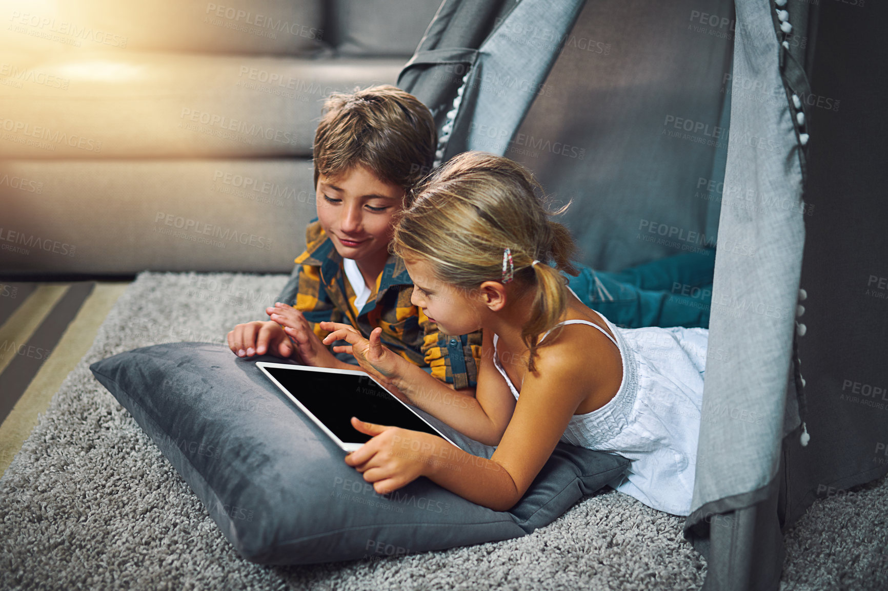 Buy stock photo Tablet, relax and kids in tent in home playing online educational game for learning. Rest, digital technology and children siblings watching video for entertainment in blanket fort for fun at home.