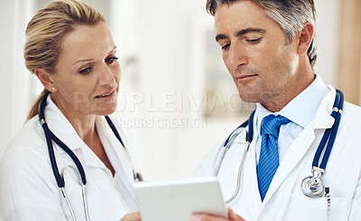 Buy stock photo Doctors, man and woman with tablet, report and thinking for research, telehealth and app. Mature people, partnership and digital touchscreen for healthcare, reading or review for wellness in clinic