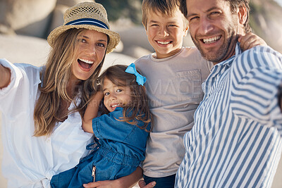 Buy stock photo Family, portrait and selfie on beach for travel, holiday and bonding together in summer while carrying. Mom, dad and kids by ocean for fun trip, vacation and social media with happiness and memory