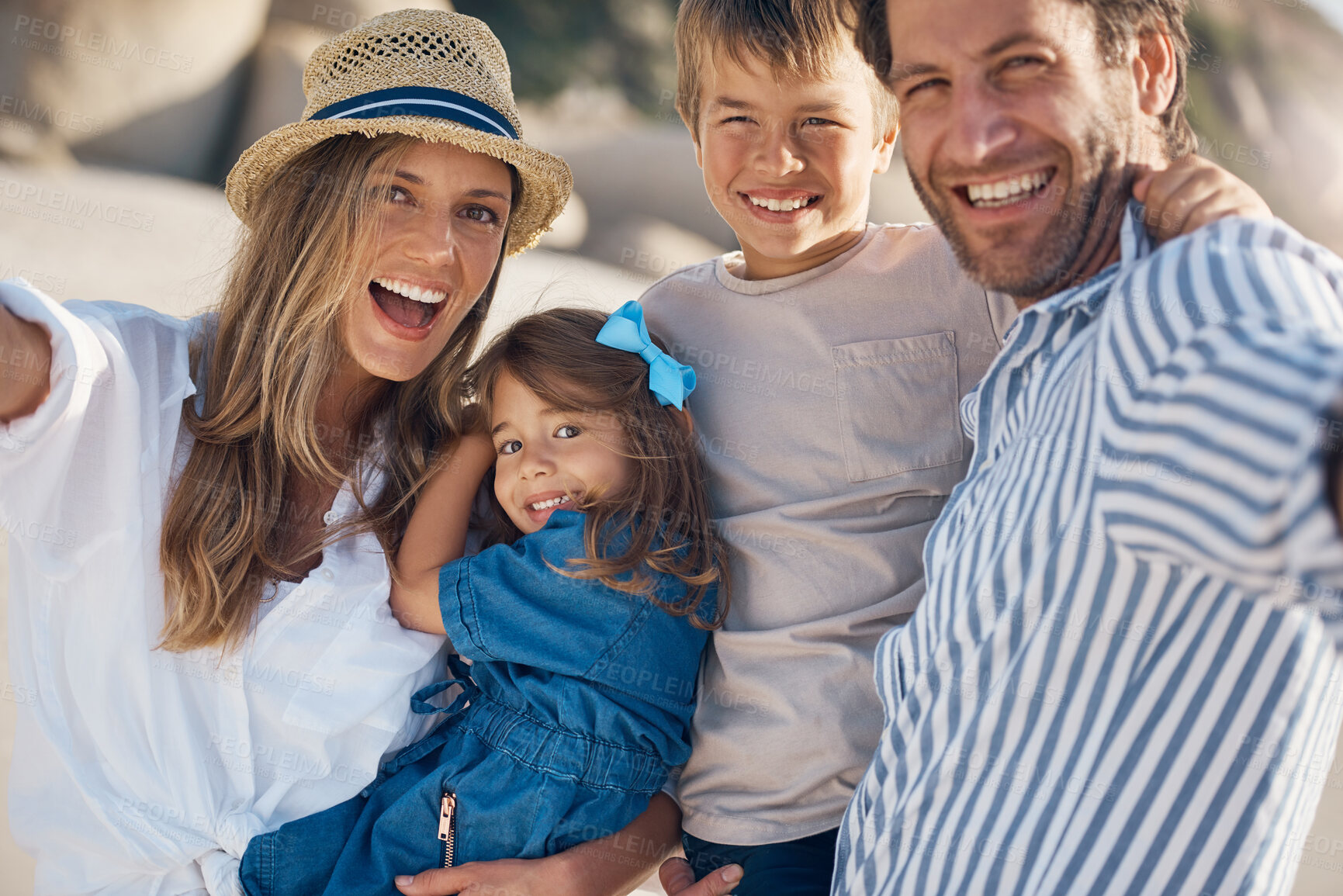 Buy stock photo Family, portrait and selfie on beach for travel, holiday and bonding together in summer while carrying. Mom, dad and kids by ocean for fun trip, vacation and social media with happiness and memory