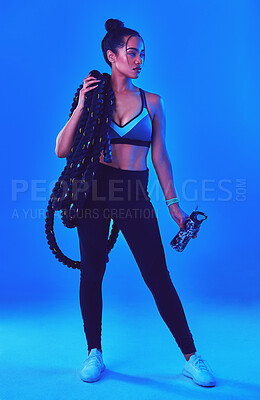 Buy stock photo Fitness, battle rope and woman with water in studio for bodybuilder workout, training and exercise. Personal trainer, gym and person with equipment for health, wellness and muscle on blue background