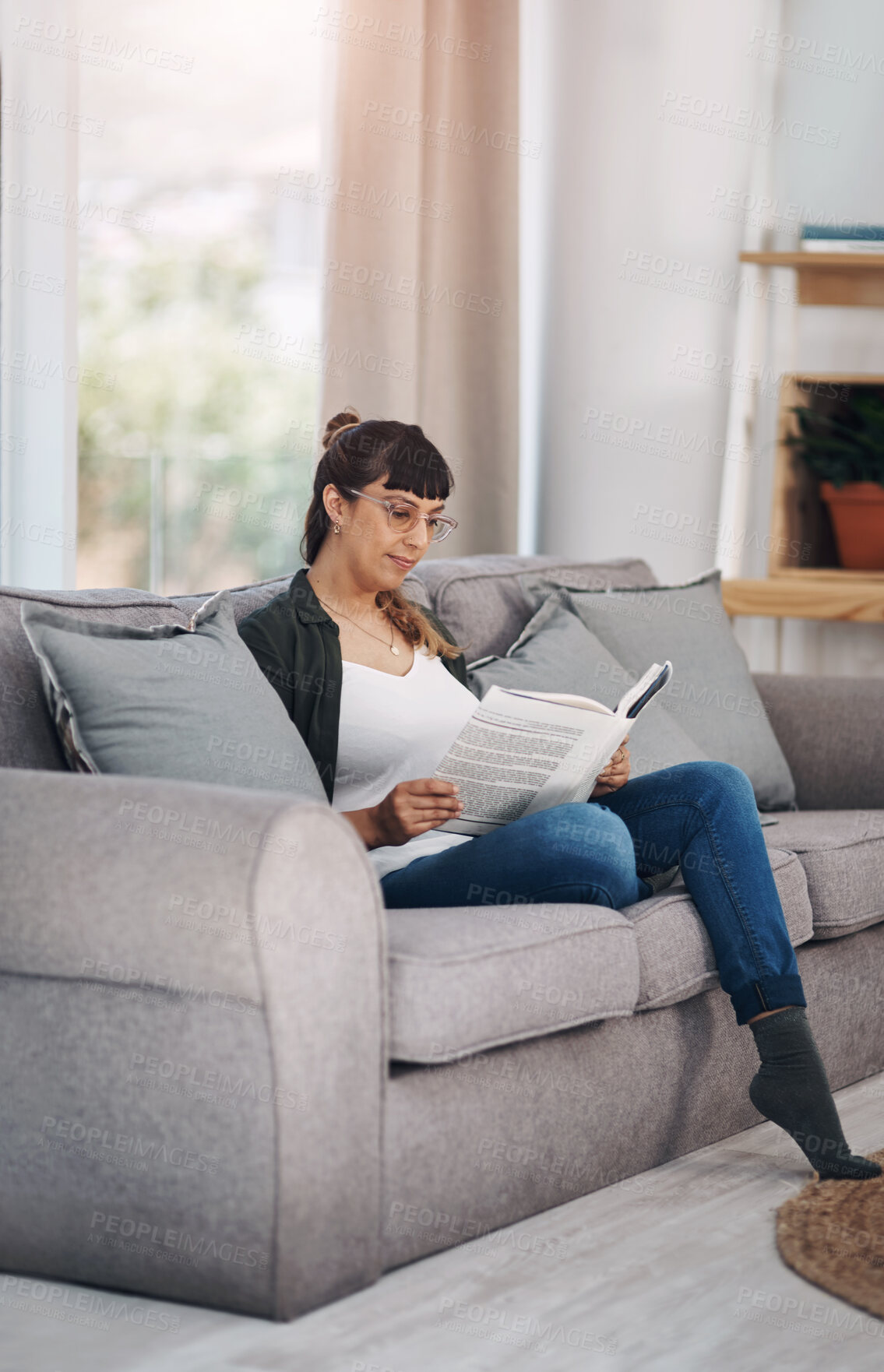 Buy stock photo Rest, reading and woman with book on sofa in home for calm, peace and self help literature. Weekend, relax and person in living room with non fiction novel or story for psychology knowledge in house.