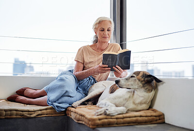 Buy stock photo Senior woman, reading book and relax with dog on sofa for learning, knowledge or comfortable together in living room. Animal, story and elderly person with pet for hobby, literature or peace in home