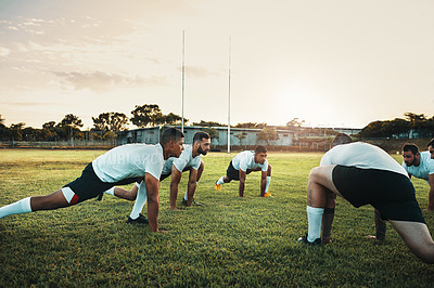 Buy stock photo Fitness, rugby and stretching for training, game and team of people on field with synergy and practice. Workout, sports and men outdoor on grass for warm up, exercise and competition with diversity