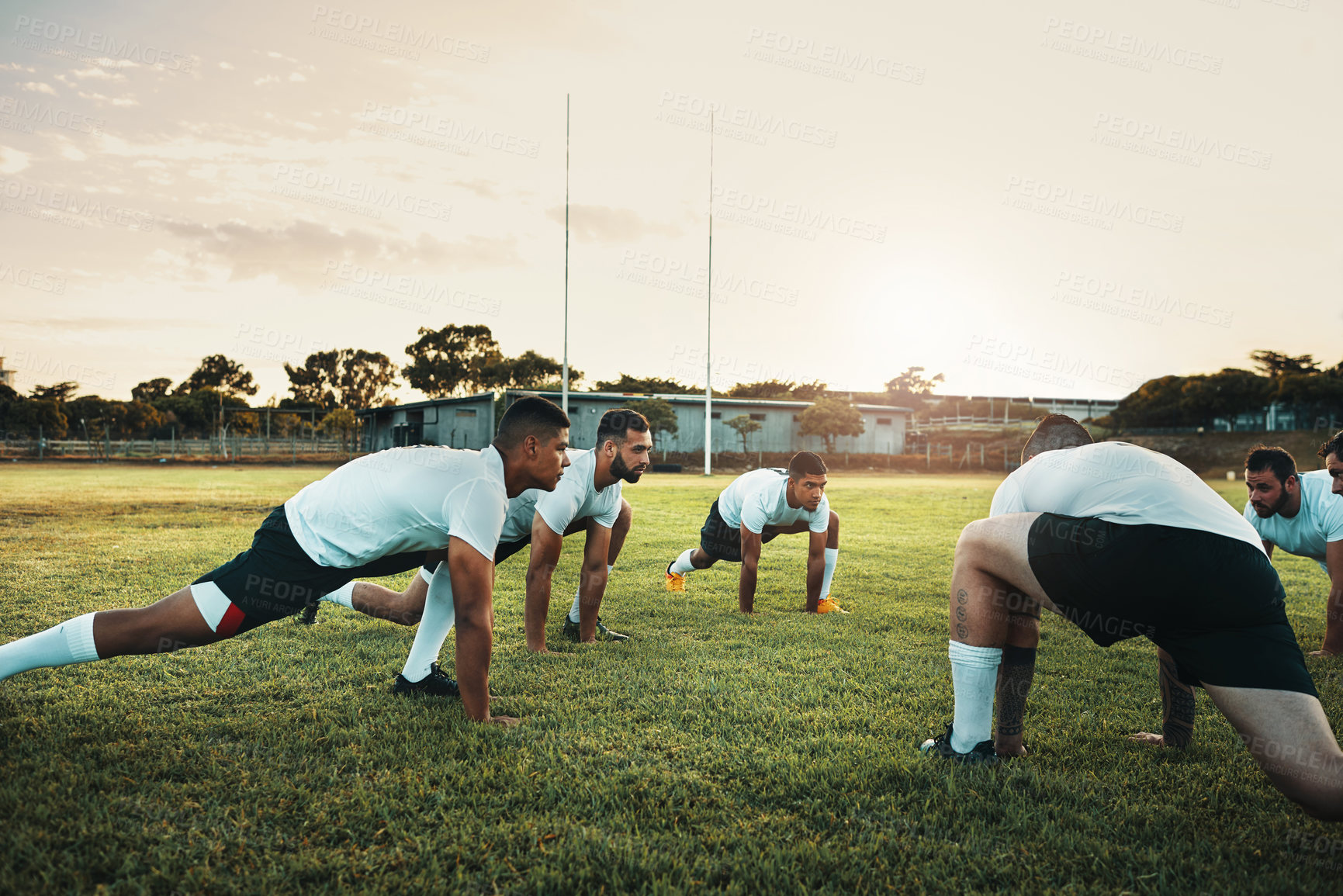 Buy stock photo Fitness, rugby and stretching for training, game and team of people on field with synergy and practice. Workout, sports and men outdoor on grass for warm up, exercise and competition with diversity