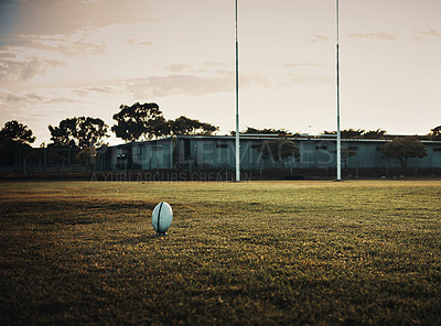 Buy stock photo Rugby, ball and field with sport, training and fitness pitch for kick exercise with goal post outdoor. Morning, practice and  school ground with game equipment and gear for match on grass at club