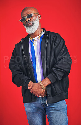 Buy stock photo Mature man, fashion and cool in vintage wear for trendy outfit, casual or pride on red background. Male person, African and accessory for fun, clothes and style with confidence or sunglasses in Kenya