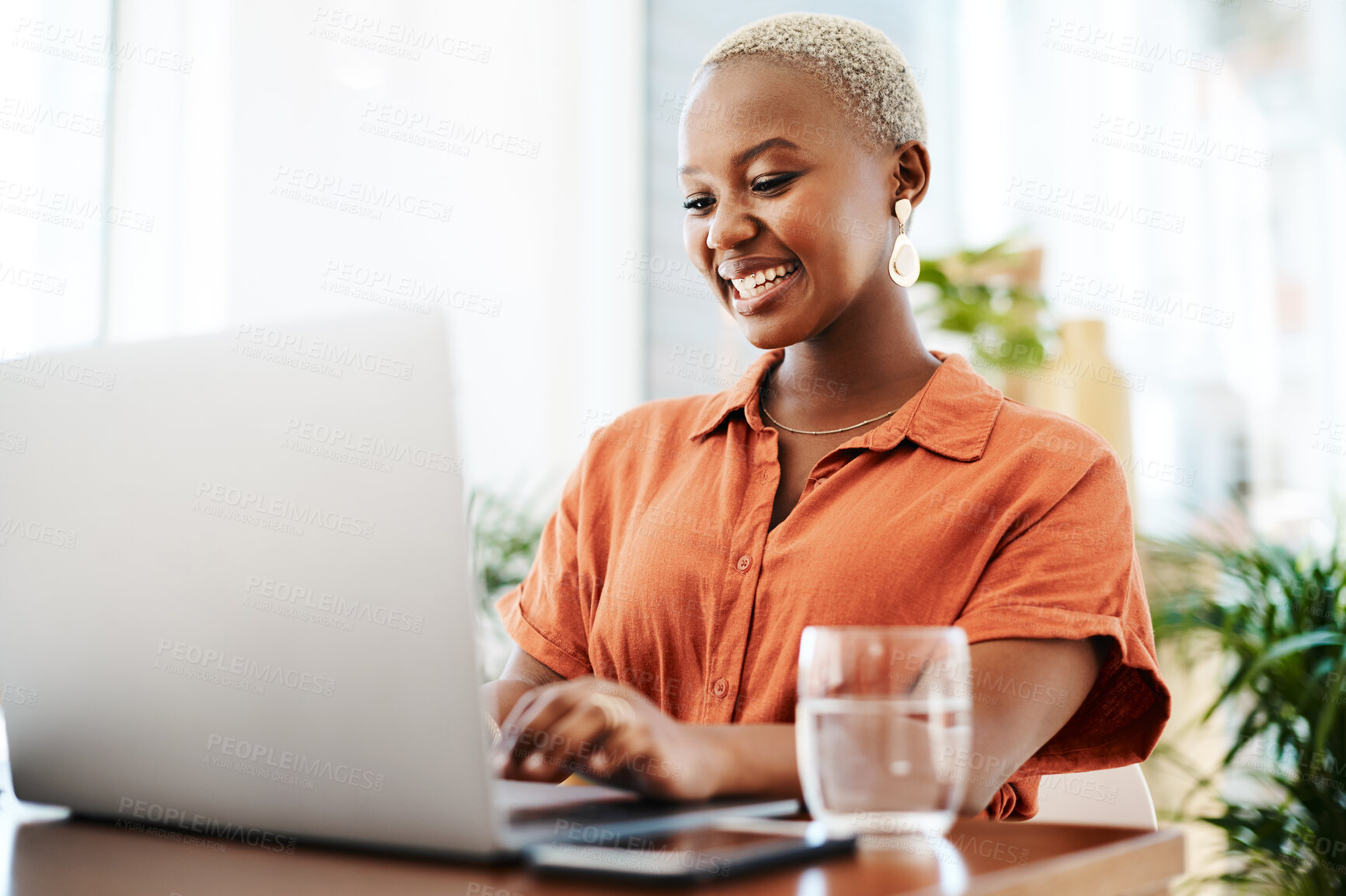 Buy stock photo Shot of a young businesswoman working on a laptop in an office