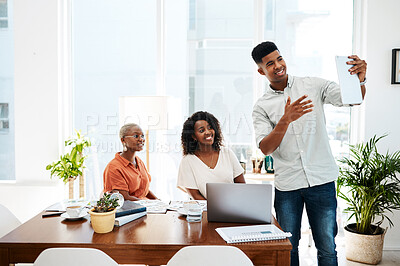 Buy stock photo Shot of a group of businesspeople using a digital tablet together during a meeting in an office