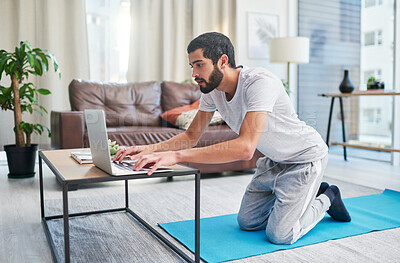 Buy stock photo Getting ready, laptop and yoga with man in living room of home for start of exercise or online class. Computer, log in or streaming with yogi person in apartment for holistic fitness or pilates