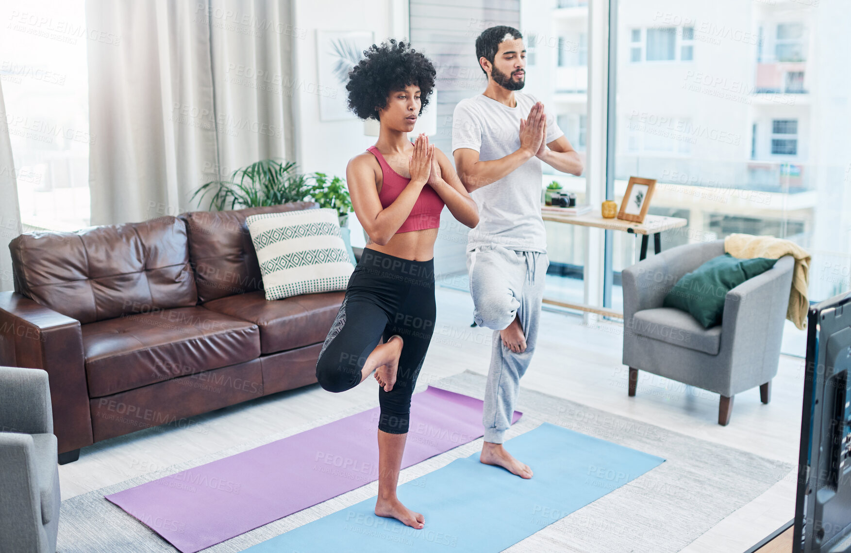 Buy stock photo House, yoga and couple in living room, calm and bonding with meditation, tv and subscription for health. Zen, mindfulness and watching of videos for tips, man and woman in lounge, spiritual or chakra