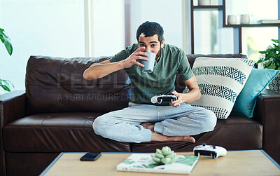 Buy stock photo Portrait, coffee and man on sofa, video game and relax with challenge, weekend break and calm. Face, apartment and person with herbal tea, hobby and guy with activity, home or espresso in living room