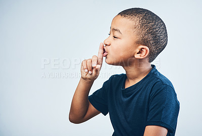 Buy stock photo Boy, child and finger to shush in studio, privacy and mystery announcement on white background. Male person, kid and secret news or gossip revelation, emoji and quiet gesture for confidential mockup