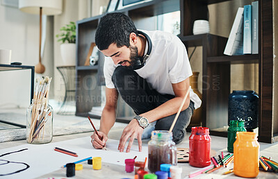 Buy stock photo Painting, relax and art with man in living room of apartment for creative design, gallery and inspiration. Painter, color pallet and watercolor with person at home for drawing, canvas and hobby