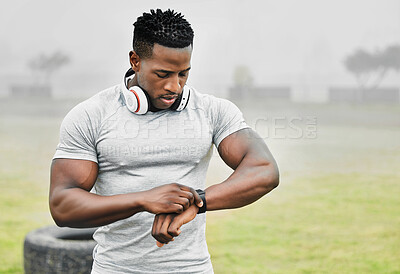 Buy stock photo Black man, exercise and smart watch with sports person outdoor, checking the time during a workout. Arm, fitness and technology with athlete tracking cardio or endurance performance while training